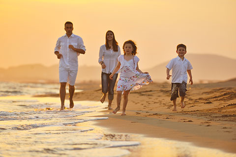 Family enjoying life insurance on the beach during sunset in Burbank
